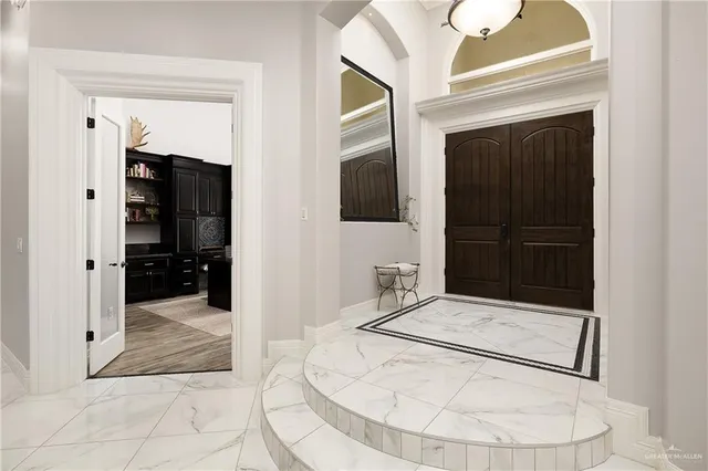 a view of a hallway with wooden floor and entryway