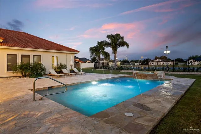 a swimming pool with outdoor seating and barbeque oven