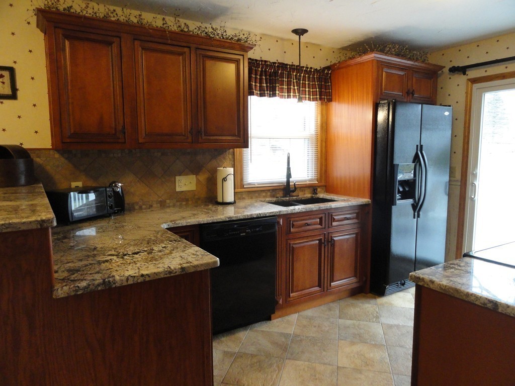 12 Laurelwood Road Rutland, MA 01543 - Photo 7 of 25 a kitchen with stainless steel appliances granite countertop a stove refrigerator and cabinets