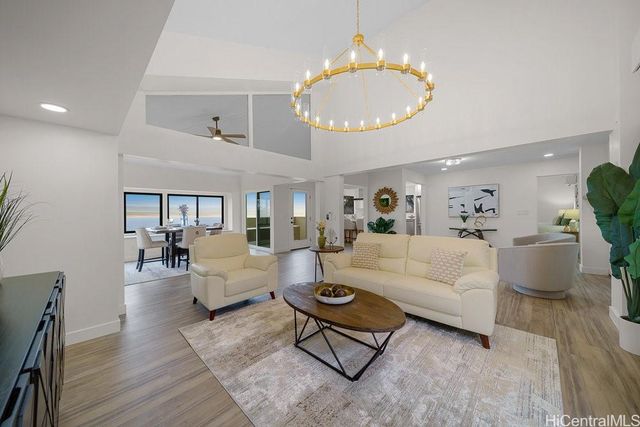a living room with furniture chandelier and a table