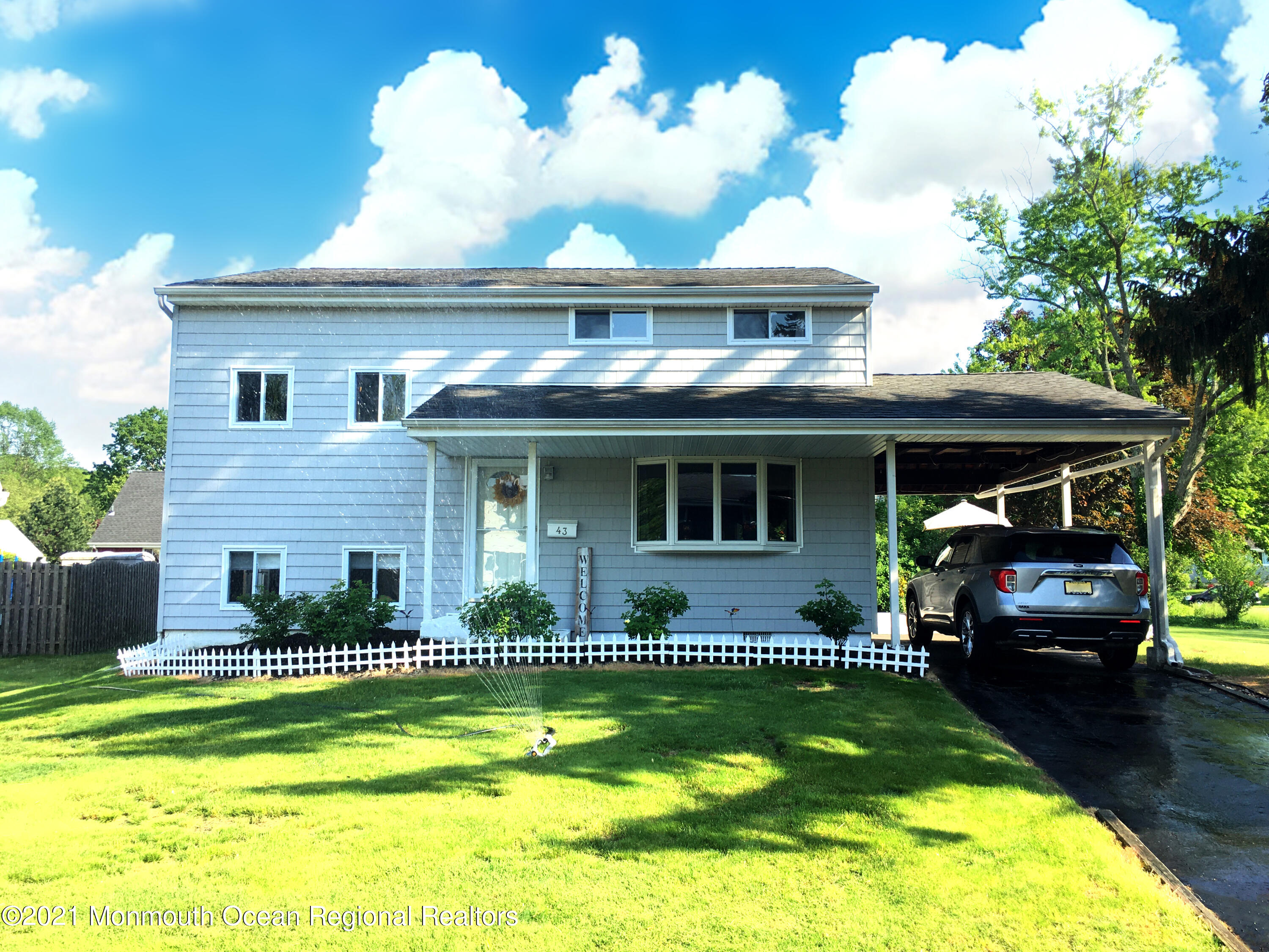 a front view of a house with a yard table and chairs