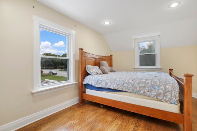 306 North Elmhurst Road Prospect Heights, IL 60070 - Photo 12 of 26 a bedroom with a bed and window