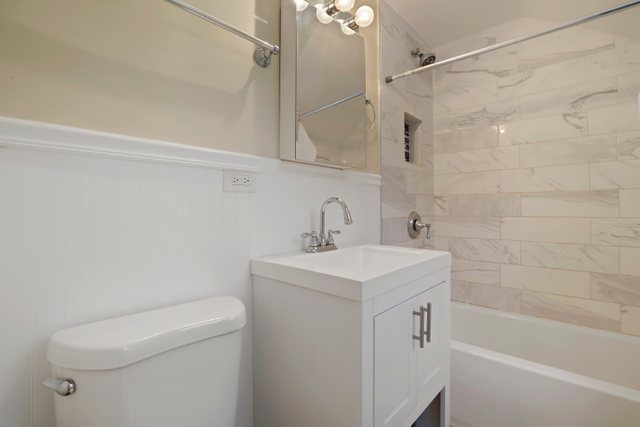 306 North Elmhurst Road Prospect Heights, IL 60070 - Photo 15 of 26 a bathroom with a sink a toilet and shower