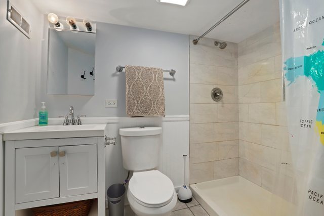 306 North Elmhurst Road Prospect Heights, IL 60070 - Photo 18 of 26 a bathroom with a sink a toilet and shower