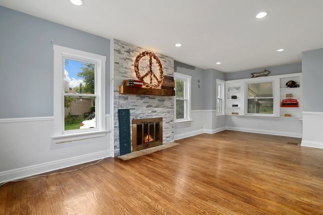 306 North Elmhurst Road Prospect Heights, IL 60070 - Photo 2 of 26 a view of an empty room with window and wooden floor