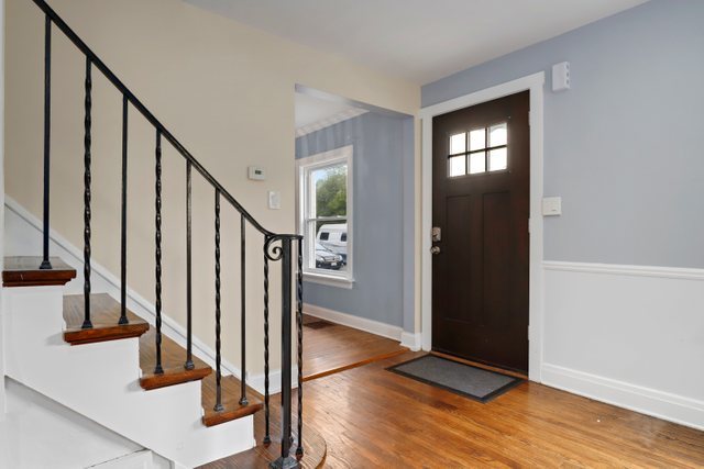 306 North Elmhurst Road Prospect Heights, IL 60070 - Photo 5 of 26 a view of an entryway with wooden floor and staircase