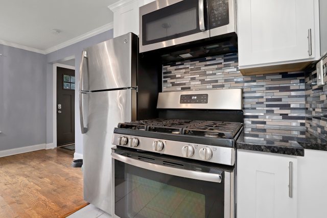 306 North Elmhurst Road Prospect Heights, IL 60070 - Photo 8 of 26 a stove top oven sitting inside of a kitchen