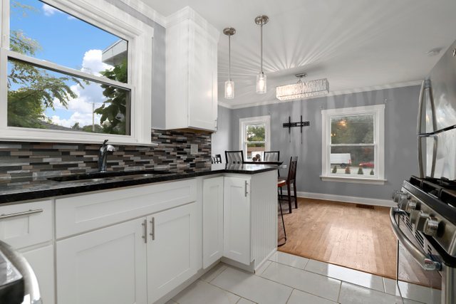 306 North Elmhurst Road Prospect Heights, IL 60070 - Photo 9 of 26 a kitchen with stainless steel appliances a stove a sink and a refrigerator