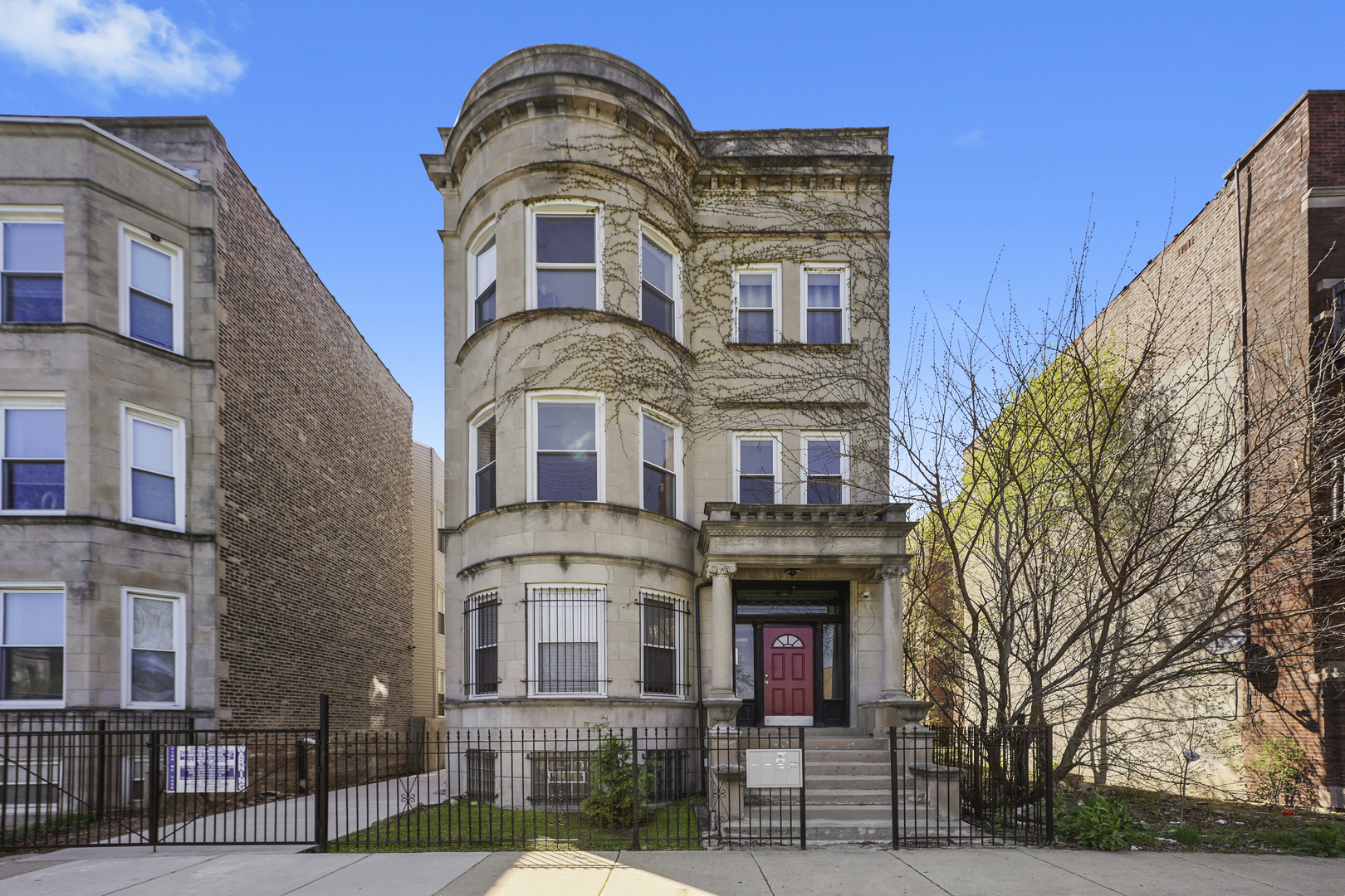 a front view of a residential apartment building with a yard