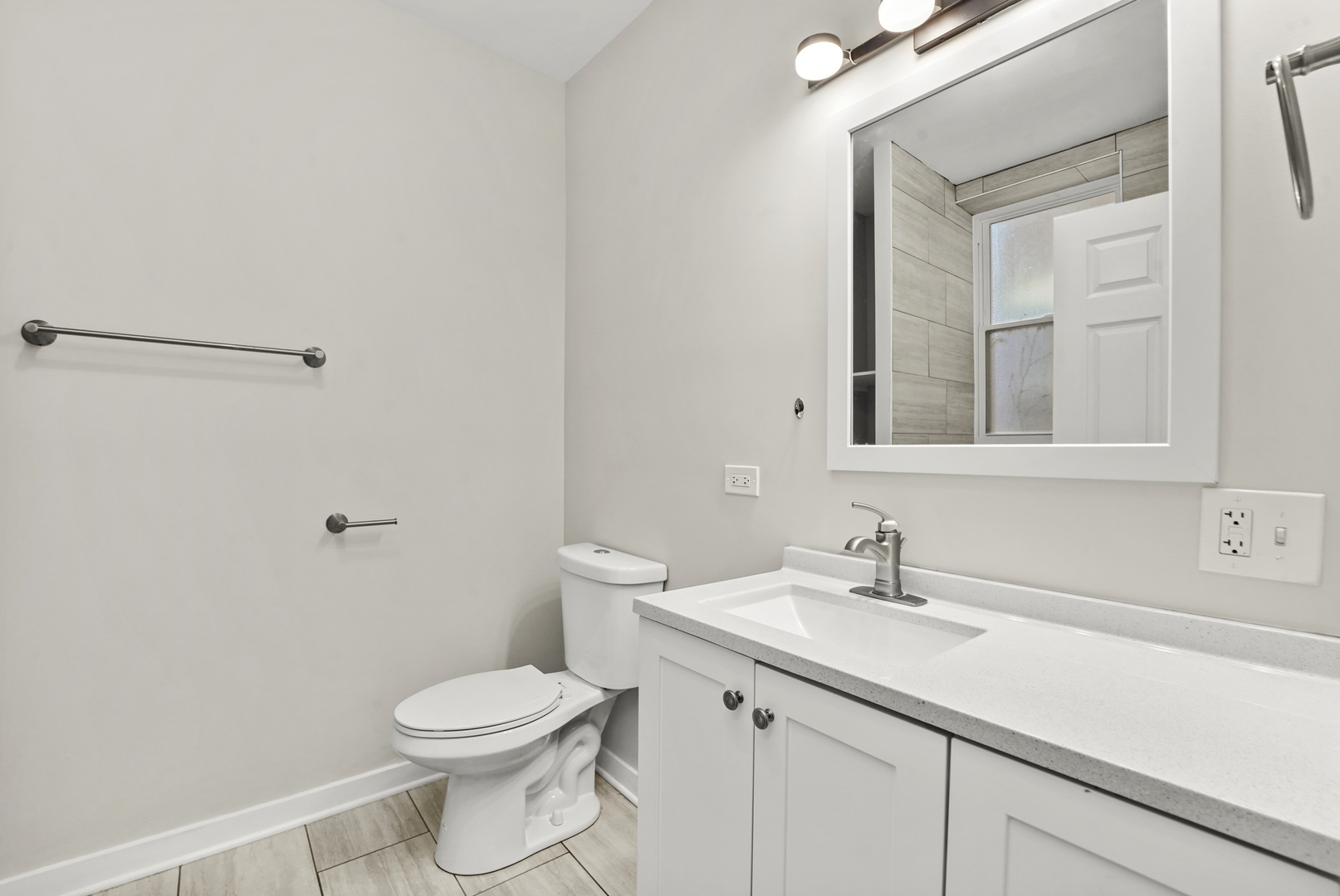 6014 South Prairie Avenue, Unit 2 Chicago, IL 60637 - Photo 6 of 10 a bathroom with a toilet sink and mirror
