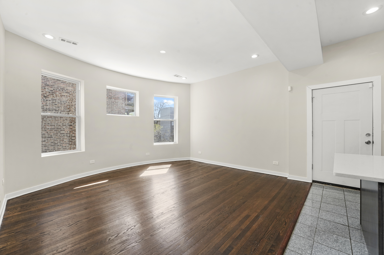 6014 South Prairie Avenue, Unit 2 Chicago, IL 60637 - Photo 7 of 10 an empty room with wooden floor and windows