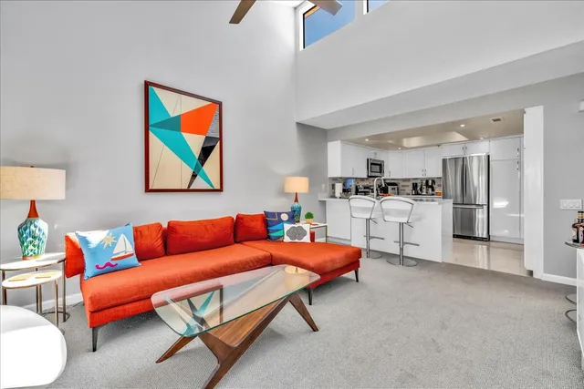 a living room with furniture and kitchen view