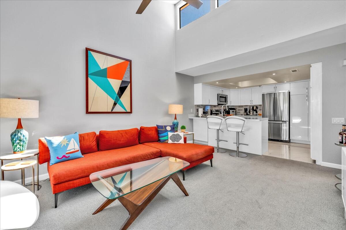 a living room with furniture and kitchen view