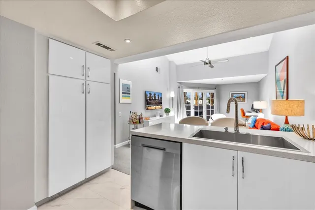 a kitchen with stainless steel appliances granite countertop a sink and cabinets