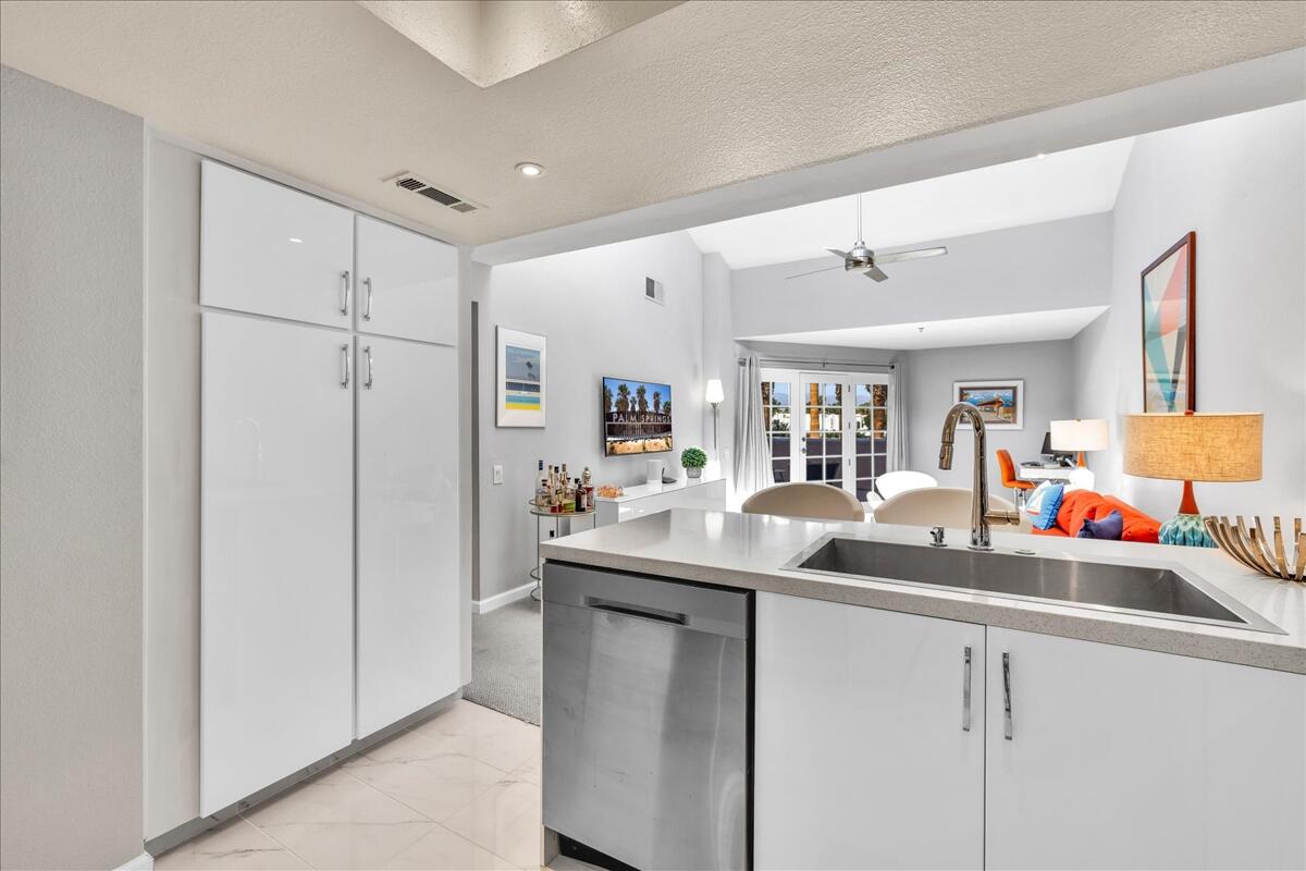 500 East Amado Road, Unit 416 Palm Springs, CA 92262 - Photo 13 of 48 a kitchen with stainless steel appliances granite countertop a sink and cabinets