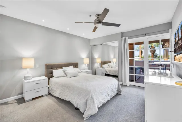 a bedroom with bed and a large window