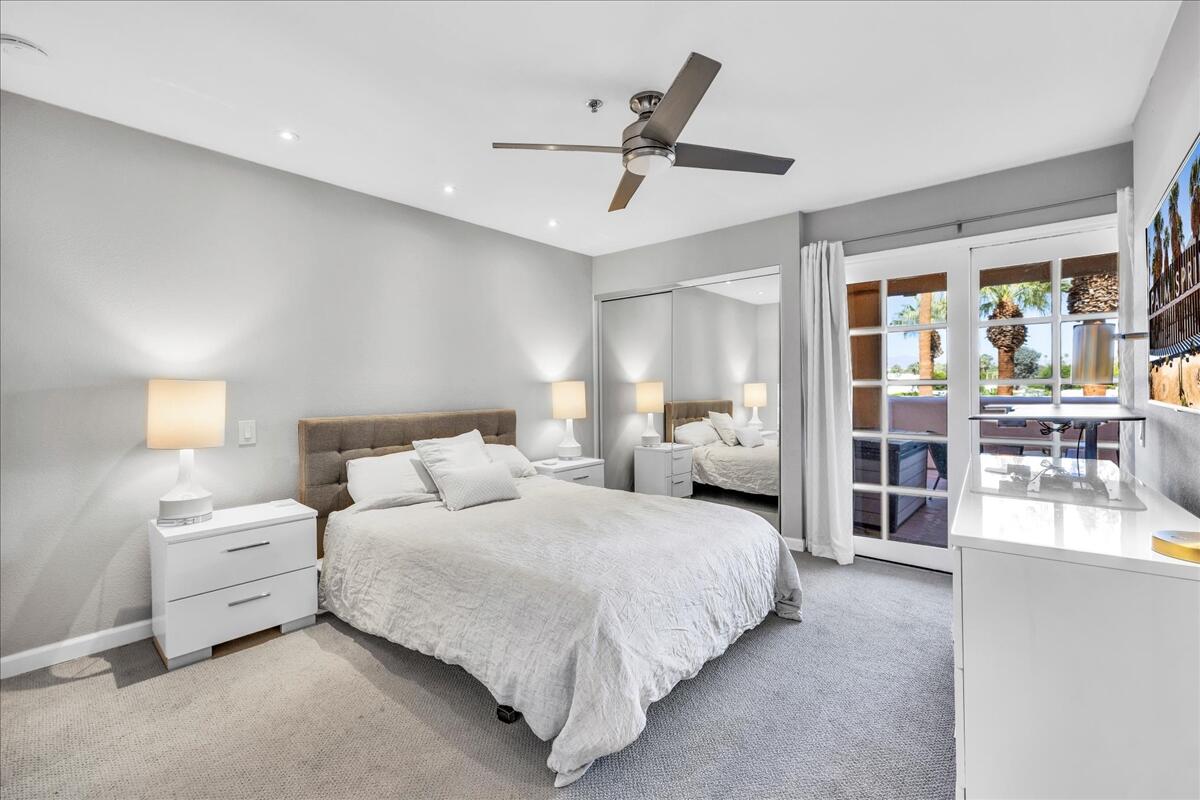 500 East Amado Road, Unit 416 Palm Springs, CA 92262 - Photo 14 of 48 a bedroom with bed and a large window