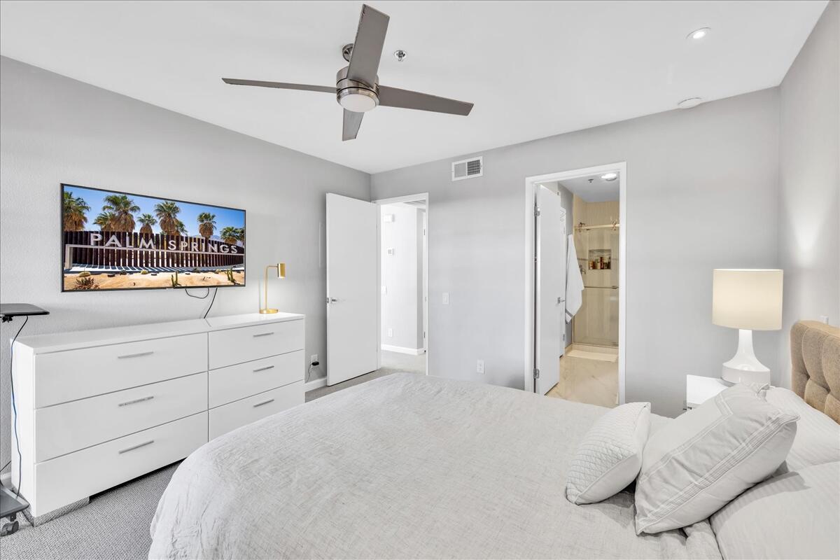 500 East Amado Road, Unit 416 Palm Springs, CA 92262 - Photo 16 of 48 a bedroom with a bed and a dresser in it