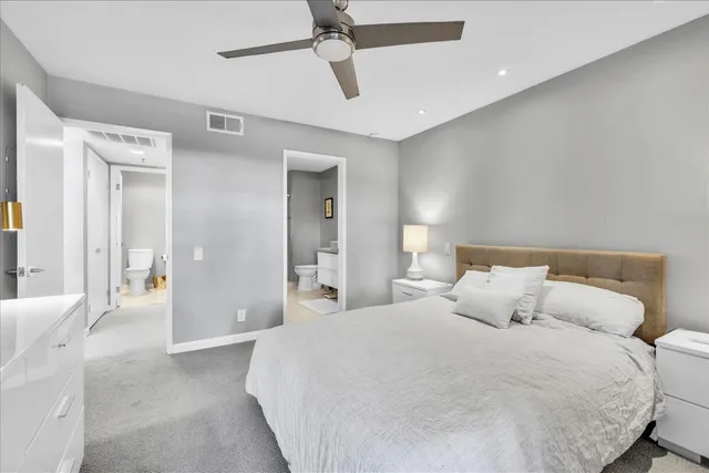 a bedroom with a bed and ceiling fan
