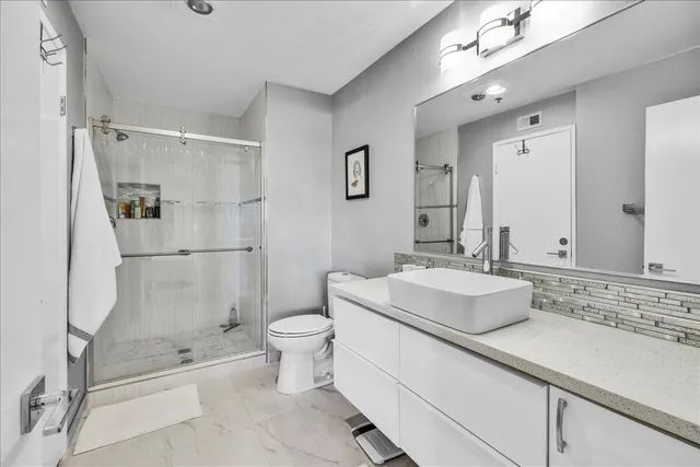 a bathroom with a sink toilet and shower