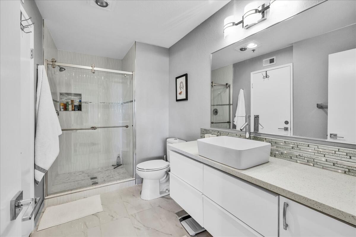 500 East Amado Road, Unit 416 Palm Springs, CA 92262 - Photo 18 of 48 a bathroom with a sink toilet and shower