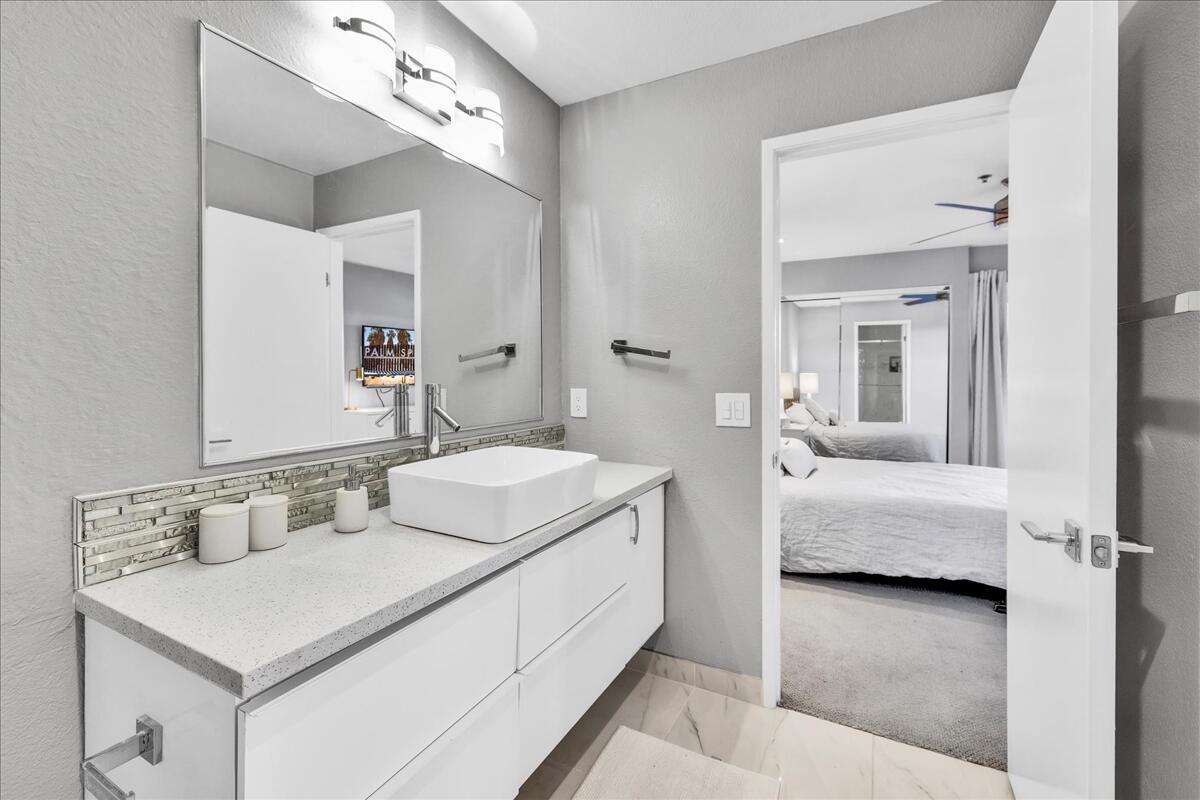 500 East Amado Road, Unit 416 Palm Springs, CA 92262 - Photo 19 of 48 a en suite bathroom with a sink and a mirror