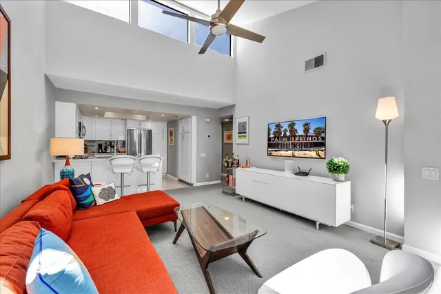 a living room with furniture and a lamp