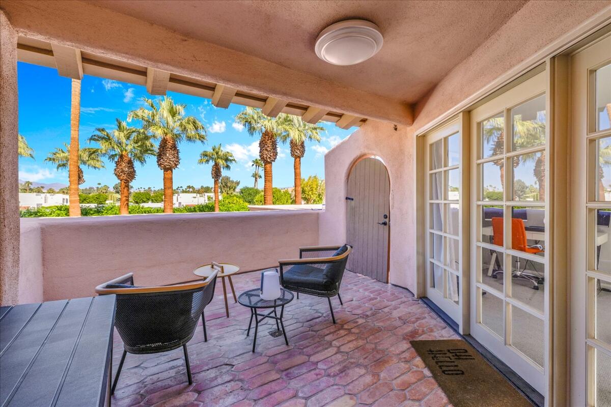 500 East Amado Road, Unit 416 Palm Springs, CA 92262 - Photo 27 of 48 a view of a dining area with furniture and a potted plant