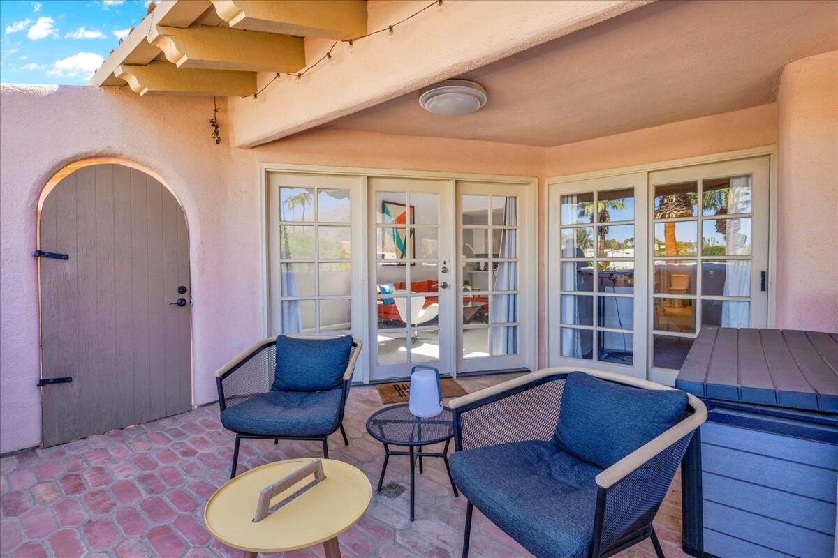 500 East Amado Road, Unit 416 Palm Springs, CA 92262 - Photo 30 of 48 a living room with furniture and wooden floor