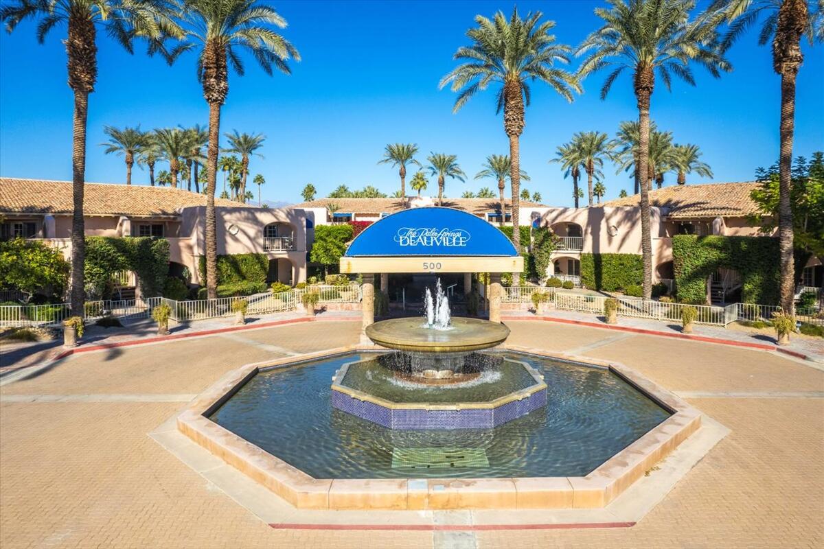 500 East Amado Road, Unit 416 Palm Springs, CA 92262 - Photo 42 of 48 a view of a swimming pool with a table and chairs