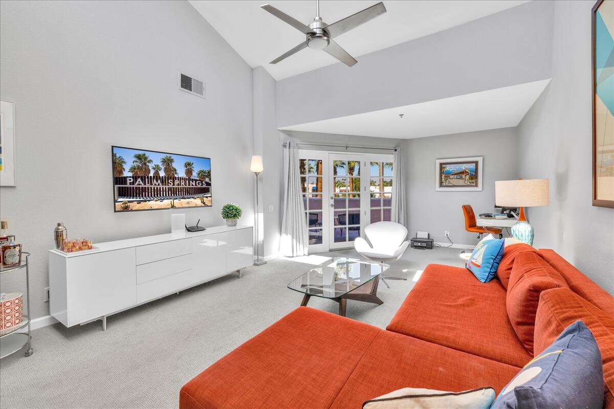 500 East Amado Road, Unit 416 Palm Springs, CA 92262 - Photo 5 of 48 a living room with furniture a flat screen tv and a couch