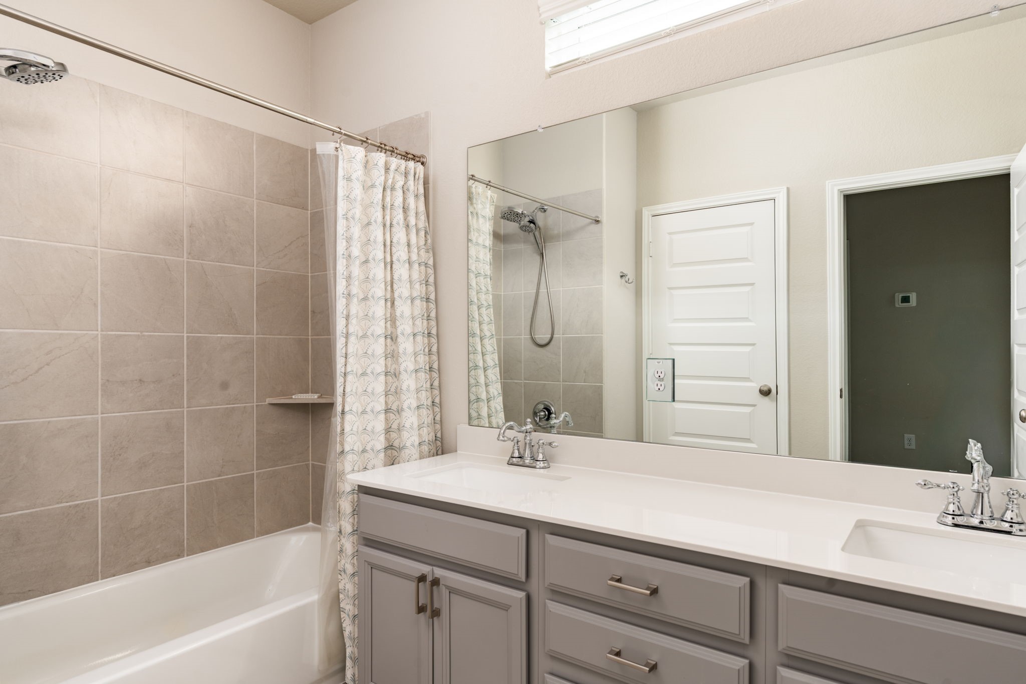 9810 Falling Fern Lane Houston, TX 77080 - Photo 15 of 30 a bathroom with a granite countertop sink a mirror and a bathtub