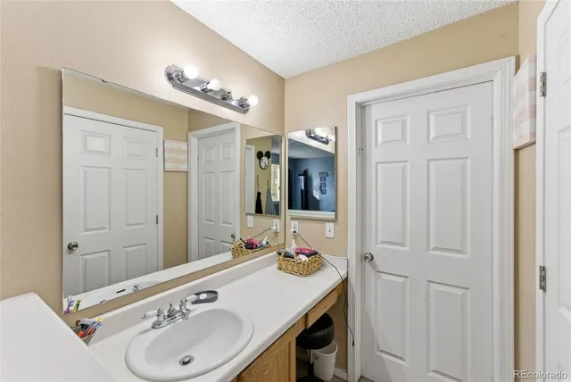 a bathroom with a sink vanity and a mirror