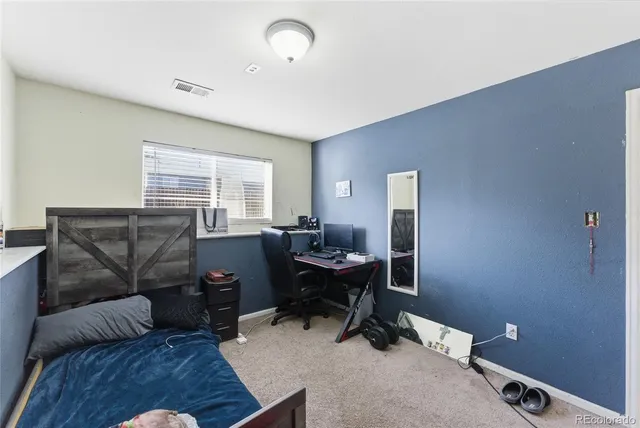 a livingroom with workspace and a couch