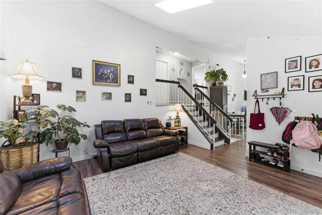 a living room with furniture and stairs