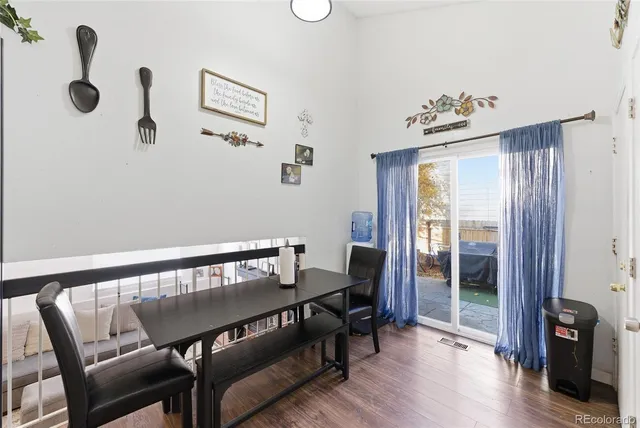 a view of a bedroom with furniture and wooden floor