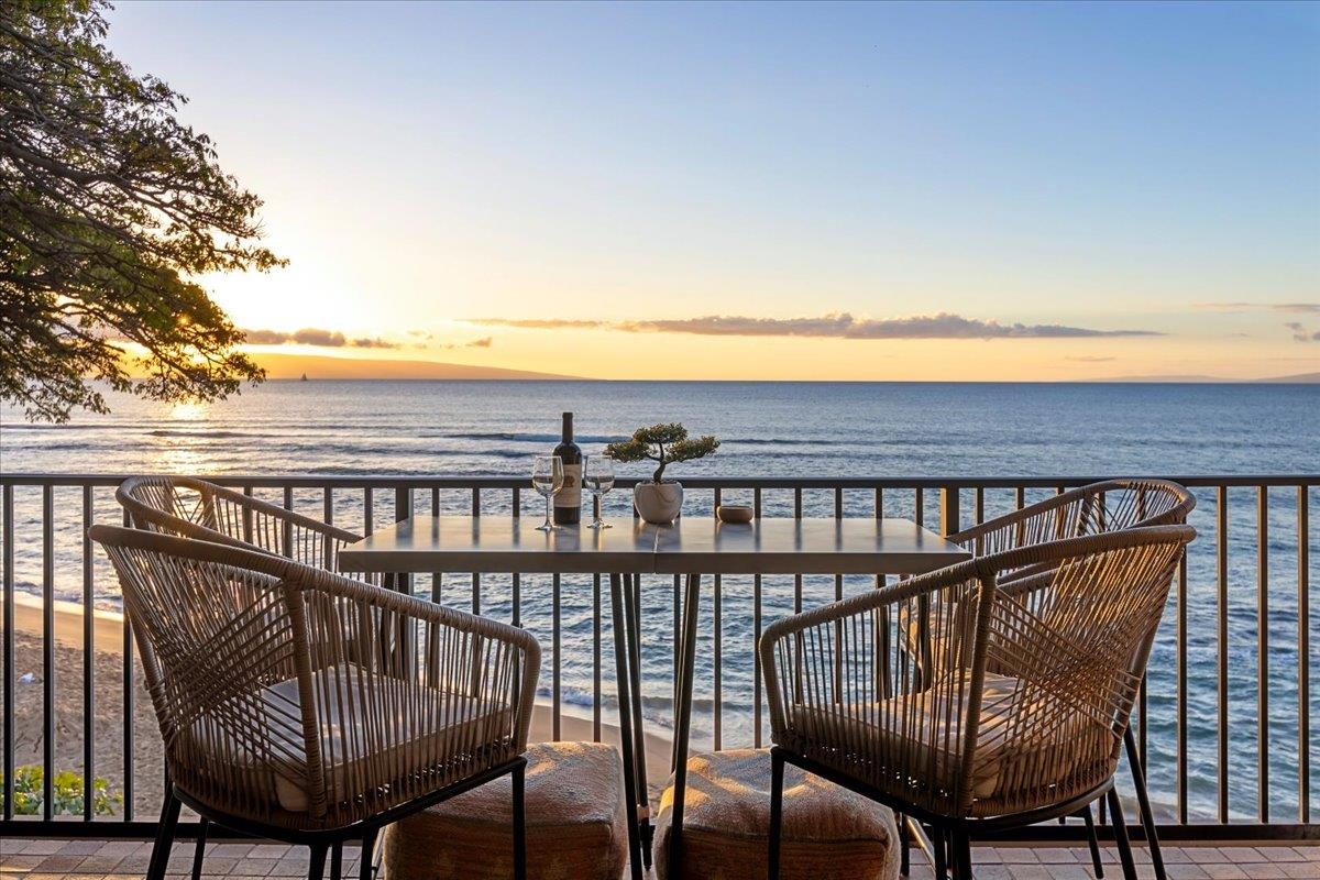 a view of a balcony with chair and iron fence