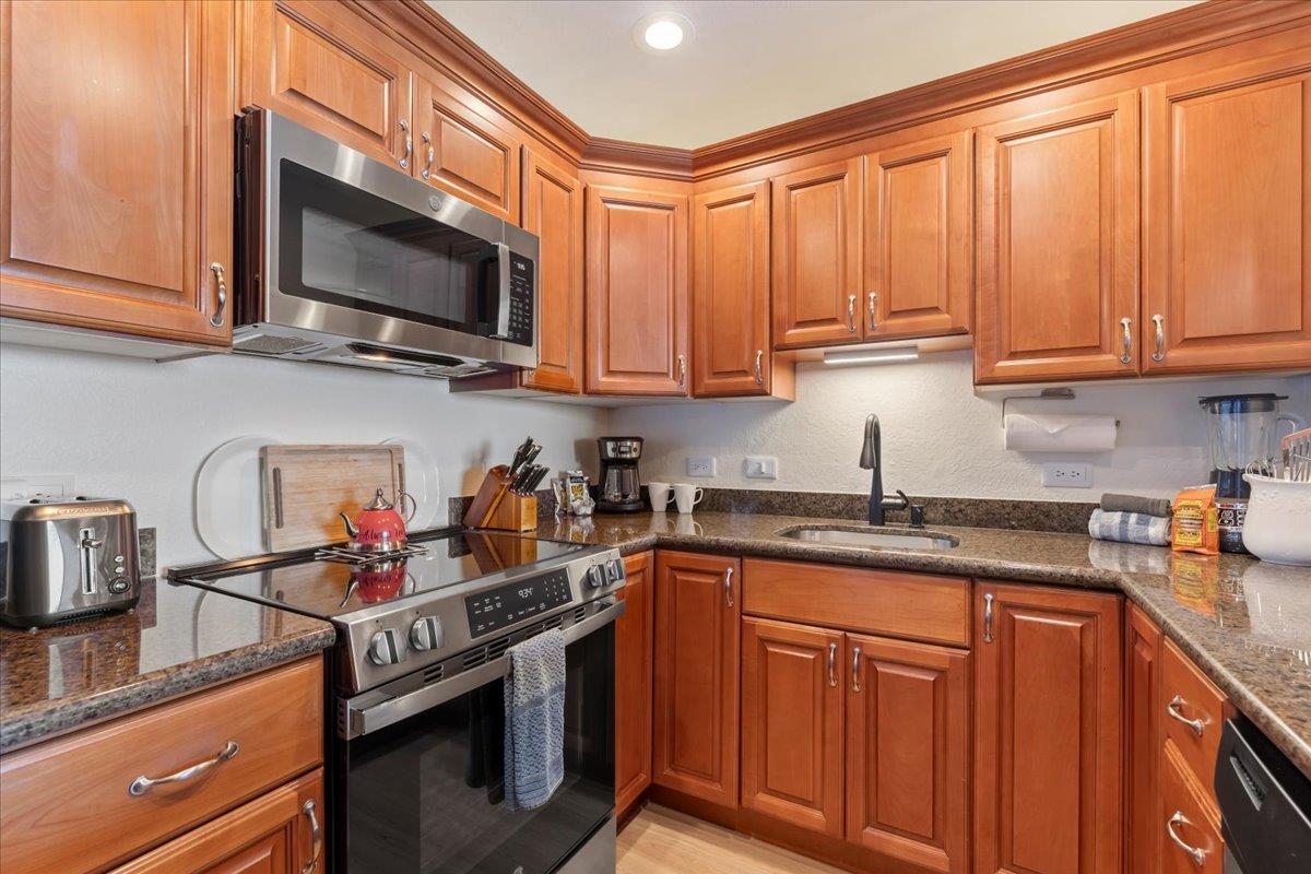 3445 Lower Honoapiilani Road, Unit 361 Lahaina, HI 96761 - Photo 12 of 43 a kitchen with stainless steel appliances granite countertop a sink stove and microwave