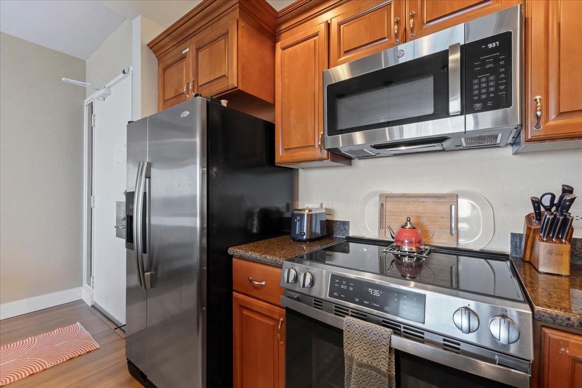 3445 Lower Honoapiilani Road, Unit 361 Lahaina, HI 96761 - Photo 14 of 43 a kitchen with stainless steel appliances granite countertop a stove and a refrigerator