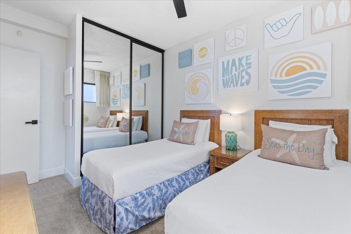 3445 Lower Honoapiilani Road, Unit 361 Lahaina, HI 96761 - Photo 26 of 43 a bedroom with two beds and painting on the wall