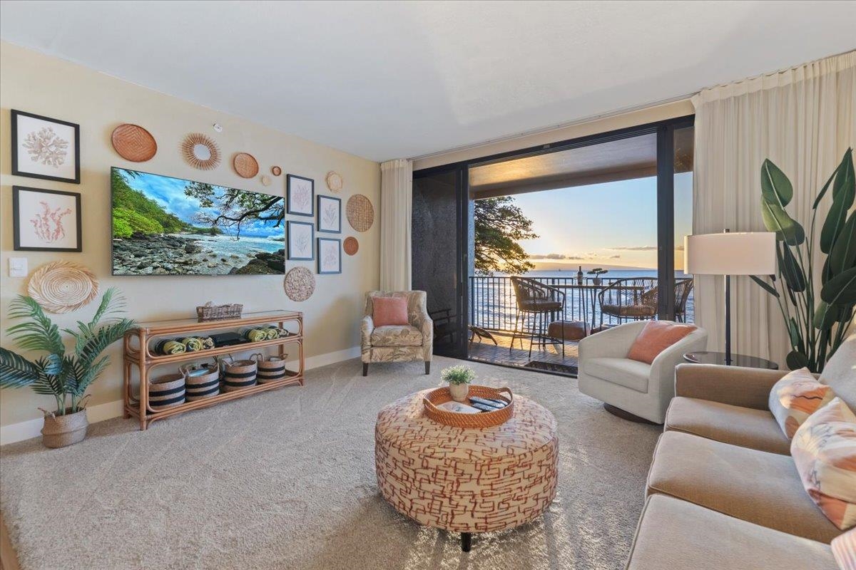 3445 Lower Honoapiilani Road, Unit 361 Lahaina, HI 96761 - Photo 3 of 43 a living room with furniture fireplace and a large window