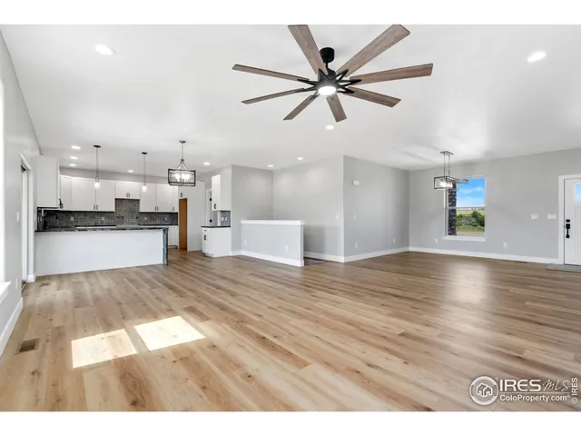a view interior of a house and kitchen with stainless steel appliances wooden floor