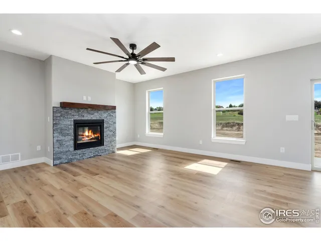 a view of an empty room with window and fireplace
