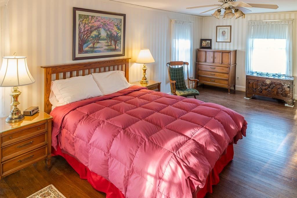30 Pickwick Road Marblehead, MA 01945 - Photo 16 of 18 a bedroom with a bed and a chandelier