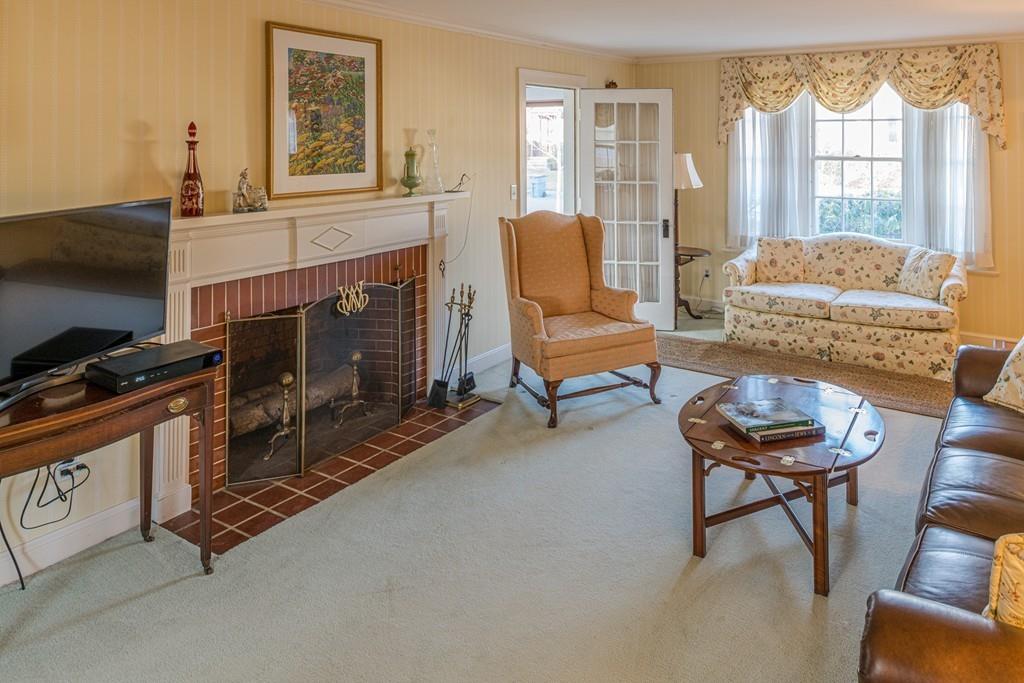 30 Pickwick Road Marblehead, MA 01945 - Photo 3 of 18 a living room with furniture a flat screen tv and a fireplace