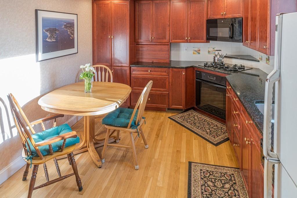 30 Pickwick Road Marblehead, MA 01945 - Photo 6 of 18 a kitchen with stainless steel appliances a stove a table and chairs