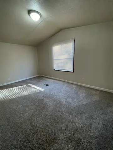 a bathroom with a granite countertop sink and a toilet