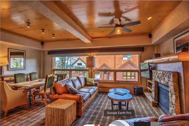 a living room with furniture a fireplace and a table