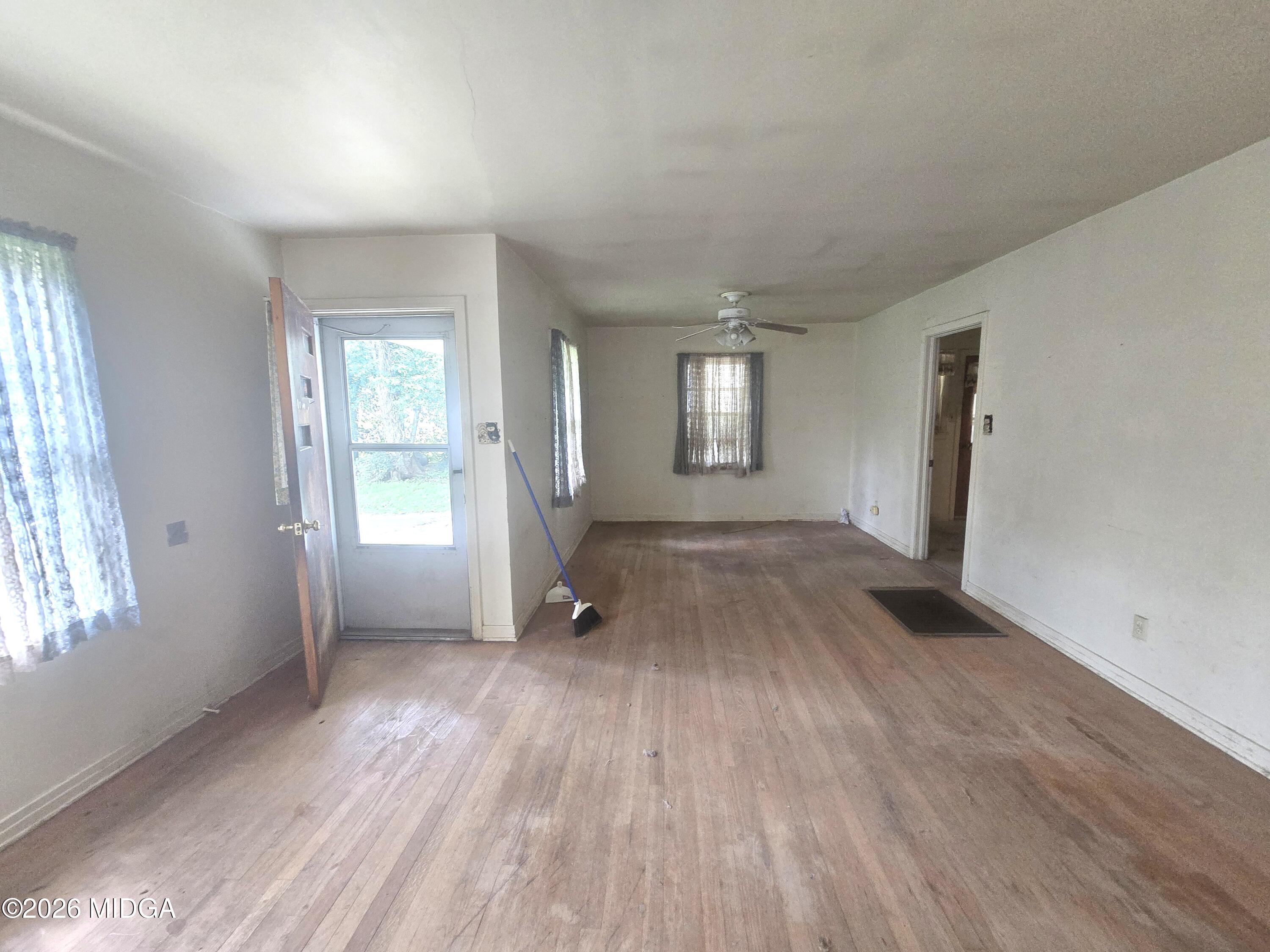 4055 Emory Drive Macon, GA 31206 - Photo 4 of 9 an empty room with wooden floor and windows