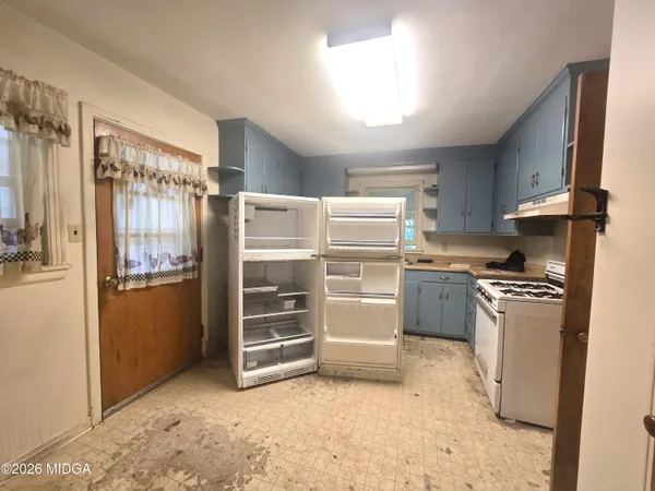a kitchen with refrigerator and stove